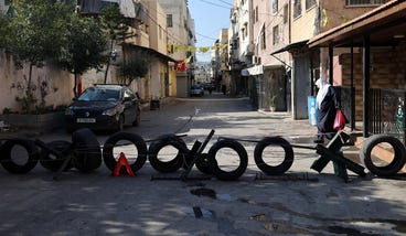 An improvised roadblock in the West Bank city of Jenin, last week., Credit: JAAFAR ASHTIYEH - AFP An improvised roadblock in the West Bank city of Jenin, last week.