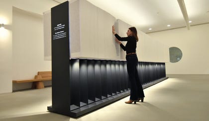 A visitor to Yad Vashem looks through the new Book of Names. Photo Yad Vashem