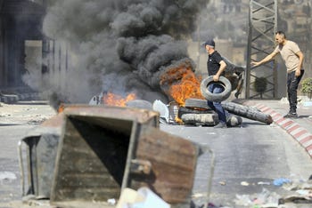 Palestinians burn tires during an IDF raid in Tubas in the West Bank, on Tuesday.