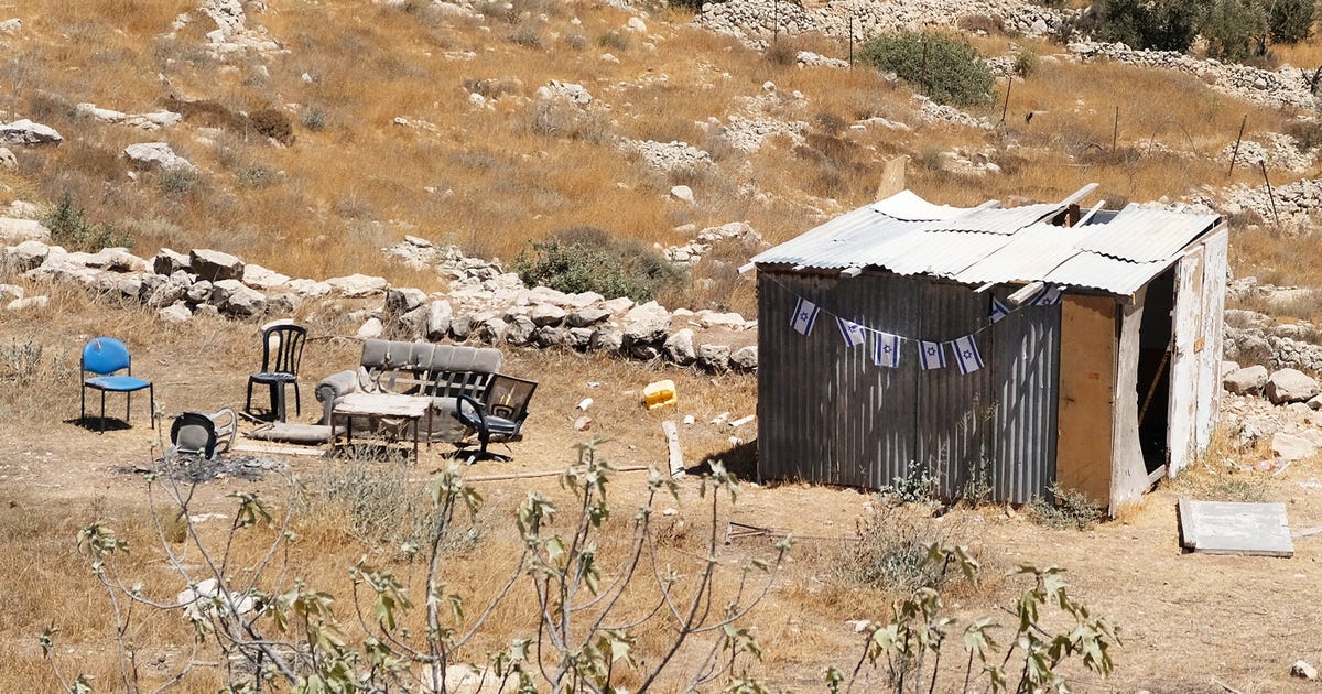 Rickety Shed Marks Territory with Israeli Flags