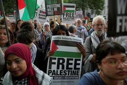 Palestinian supporters gather during a protest against President Isaac Herzog's visit outside Downing Street in London, Tuesday.