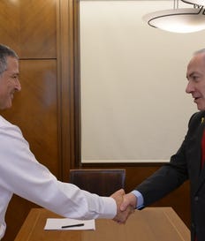 Prime Minister Benjamin Netanyahu shaking hands with David Zini in the prime minister's office.