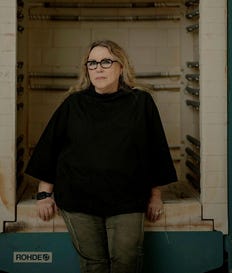 Yael Atzmoni in front of a ceramic firing kiln. Credit: Naama Grynbaum Yael Atzmoni in front of a ceramic firing kiln.