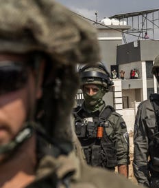 Israeli soldiers standing in front of a home where three Palestinian families are besieged in Qusra, northern West Bank, on Friday. Credit: Itai Ron Israeli soldiers standing in front of a home where three Palestinian families are besieged in Qusra, northern West Bank, on Friday.