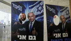 A voter poses with a Netanyahu campaign cutout at the Jerusalem International Convention Center yesterday. Credit: Itay Cohen A voter poses with a Netanyahu campaign cutout at the Jerusalem International Convention Center yesterday.