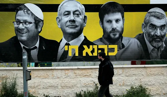 An election poster featuring Itamar Ben-Gvir (left), Benjamin Netanyahu and Bezalel Smotrich, 2019. The poster reads "Kahane lives," in reference to extremist rabbi Meir Kahane, who founded the radical Kach party. Kahane was banned from Israeli politics in 1988. Credit: Thomas Coex/AFP An election poster featuring Itamar Ben-Gvir (left), Benjamin Netanyahu and Bezalel Smotrich, 2019. The poster reads "Kahane lives," in reference to extremist rabbi Meir Kahane, who founded the radical Kach party. Kahane was banned from Israeli politics in 1988.