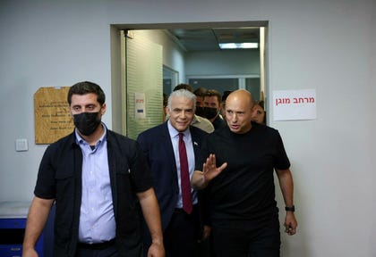 Former Prime Ministers Yair Lapid and Naftali Bennett arrive at a conference unveiling the Together party's security and foreign policy platform in Tel Aviv on Wednesday.