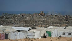 Palestinians search through a garbage dump for combustible materials to use as fuel for cooking due to a shortage of cooking gas, in Deir al-Balah, central Gaza Strip, Saturday.