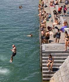 Basel residents floating in the Rhine. The whole city was invited to the river, and ice cream stands were set up along its banks.
