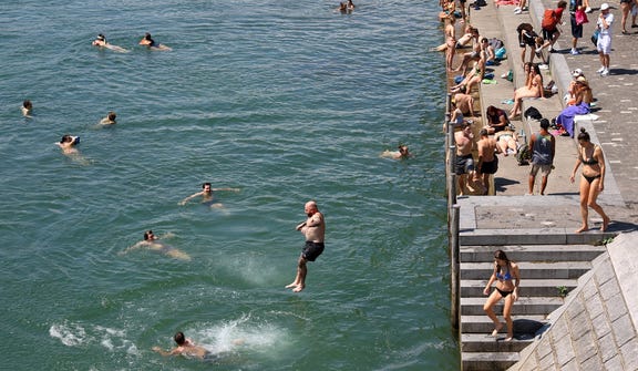 Basel residents floating in the Rhine. The whole city was invited to the river, and ice cream stands were set up along its banks.