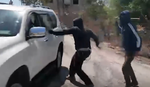 The masked settlers recorded as they attack the NBC crew in the West Bank, on Saturday.