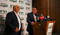 Leader of the United Arab List Mansour Abbas and Yoav Segalovitz attend a news conference in Nazareth on Monday.