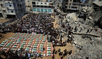 Palestinians attend the funeral of 112 members of the Hassayna and Abu Sharia clan, who were killed in an Israeli strike in 2023 and whose remains were recovered from beneath the rubble, according to Gaza's Civil Defense, in Gaza City, in August.