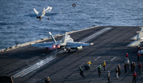 An F/A-18E Super Hornet, attached to Strike Fighter Squadron (VFA) 151, and an EA-18G Growler, attached to Electronic Attack Squadron (VAQ) 133, launch from the flight deck of the USS Abraham Lincoln aircraft carrier, in May.