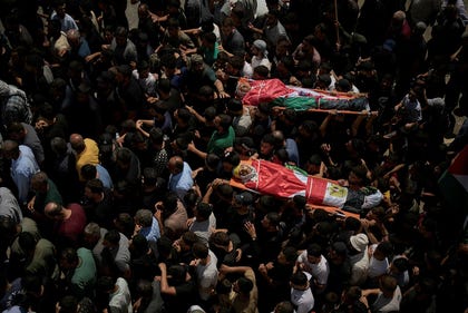 Funeral of the two youths killed by the IDF in al-Mughayyir, Wednesday. Credit: Leo Correa/AP Funeral of the two youths killed by the IDF in al-Mughayyir, Wednesday.