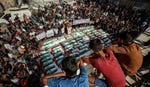 Mourners gather for a mass burial of around 100 Palestinians, including 62 children, whose remains where recovered from rubble, in Gaza City, on Sunday. Credit: AFP/OMAR AL-QATTAA Mourners gather for a mass burial of around 100 Palestinians, including 62 children, whose remains where recovered from rubble, in Gaza City, on Sunday.