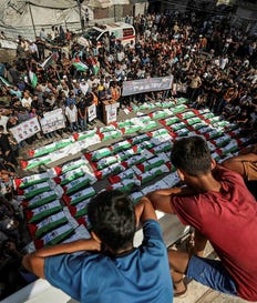 Mourners gather for a mass burial of around 100 Palestinians, including 62 children, whose remains where recovered from rubble, in Gaza City, on Sunday. Credit: AFP/OMAR AL-QATTAA Mourners gather for a mass burial of around 100 Palestinians, including 62 children, whose remains where recovered from rubble, in Gaza City, on Sunday.