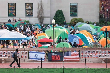 Israeli and U.S. flags are seen alongside portraits of Israeli hostages in front of the pro-Palestine encampment at Columbia University in New York on April 23, 2024. Credit: Charly Triballeau/AFP Israeli and U.S. flags are seen alongside portraits of Israeli hostages in front of the pro-Palestine encampment at Columbia University in New York on April 23, 2024.