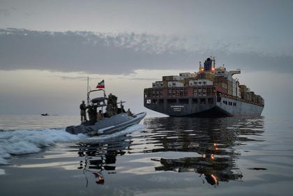 A Revolutionary Guard Navy (IRGC) speedboat approaches the cargo ship Epaminondas during what state media described as the seizure of one of two vessels accused of violations in the Strait of Hormuz, April.