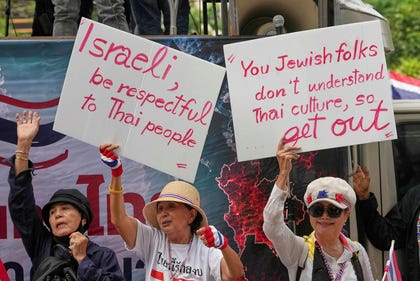 Protesters holding signs attend a demonstration demanding an end to alleged land-grabbing by foreigners, in front of Israeli Embassy in Bangkok, Thailand, Thursday. Credit: Sakchai Lalit/AP Protesters holding signs attend a demonstration demanding an end to alleged land-grabbing by foreigners, in front of Israeli Embassy in Bangkok, Thailand, Thursday.
