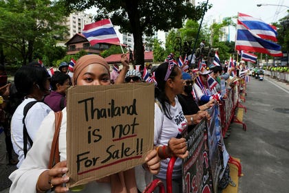 Protesters holding signs attend a demonstration demanding an end to alleged land-grabbing by foreigners, in front of Israeli Embassy in Bangkok, Thailand, Thursday. Credit: Sakchai Lalit/AP Protesters holding signs attend a demonstration demanding an end to alleged land-grabbing by foreigners, in front of Israeli Embassy in Bangkok, Thailand, Thursday.