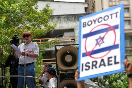 A media owner and political activist, Sondhi Limthongkul speaks to a crowd of followers, demanding an end to alleged land-grabbing by foreigners, in front of Israeli Embassy in Bangkok, Thailand, Thursday.