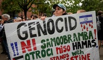 A pro-Palestine protester holds a placard reading "Genocide is not self defense, children are not Hamas, Slovenia stands with Palestine" during a rally outside the newly opened Israeli embassy in Ljubljana, Slovenia, Wednesday, Sept. 9, 2026. (AP Photo/Darko Bandic)