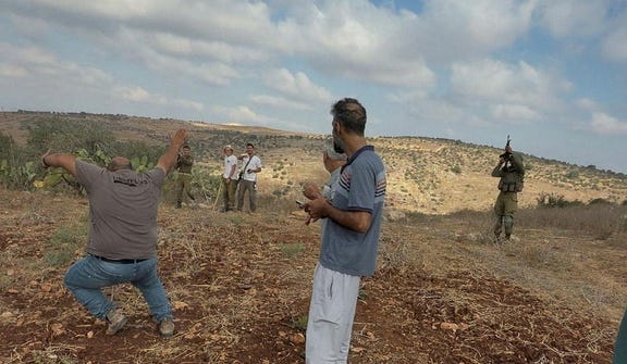 A Palestinian man falls as he gets injured in the leg after Israeli soldiers intervened following Israeli militant settlers attack, locals say, near Jenin, in the West Bank, Saturday. Credit: Video Obtained by Reuters A Palestinian man falls as he gets injured in the leg after Israeli soldiers intervened following Israeli militant settlers attack, locals say, near Jenin, in the West Bank, Saturday.