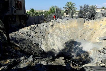 A view of a crater at the site of a deadly Israeli airstrike on a house in Khan Yunis, southern Gaza Strip, 2023.