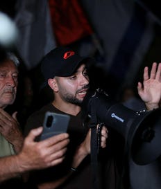 Right-wing agitator Mordechai David speaks through a megaphone at a demonstration outside the house of "NAZA" film co-director Rachel Szor's parents, Wednesday. Credit: Hadas Parush Right-wing agitator Mordechai David speaks through a megaphone at a demonstration outside the house of "NAZA" film co-director Rachel Szor's parents, Wednesday.