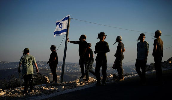 Israeli settlers gather to celebrate the inauguration of a newly built synagogue at the occupied West Bank outpost of Homesh, Wednesday.