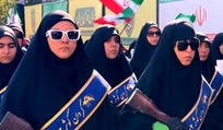 Women march in a government-organized rally in Tehran, Iran, on Friday.