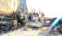 Houthi fighters stand in front of what they say is a downed Saudi jet, at a location given as Yemen, in this still image from a handout video released on September 16, 2026.