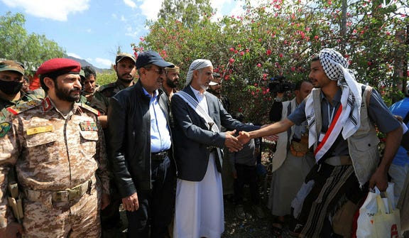 Mohammed Ahmed Miftah (C-L), the Houthi authority's caretaker prime minister, greets released prisoners loyal to the authority who were held on the west coast by Yemen's Saudi-backed government forces, in the capital Sanaa, earlier this month.