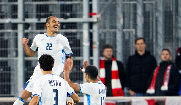 Israel's players celebrate during last Thursday's match against Austria. Credit: AFP/Georg Hochmuth Israel's players celebrate during last Thursday's match against Austria.