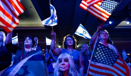 A crowd of mostly Evangelical Christians waves U.S. and Israeli flags during a Christians United For Israel (CUFI) event in Washington.