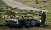 A Palestinian man inspects a car that was torched by Israeli settlers in the West Bank earlier this year. Credit: Majdi Mohammed/AP A Palestinian man inspects a car that was torched by Israeli settlers in the West Bank earlier this year.