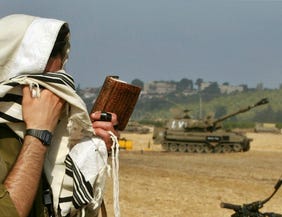 An Israeli soldier praying near the border with Lebanon.