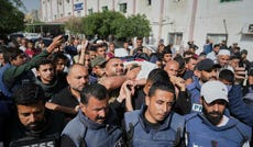 Palestinians carry the body of journalist Hassan Eslaiah in Khan Yunis, May 2025.