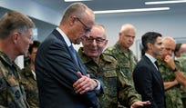 German Chancellor Friedrich Merz (center, left) talks with the Inspector General of the Bundeswehr Carsten Breuer (center, right) as he visits the German-Netherlands Corps in Muenster, western Germany, on Thursday.
