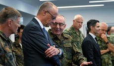 German Chancellor Friedrich Merz (center, left) talks with the Inspector General of the Bundeswehr Carsten Breuer (center, right) as he visits the German-Netherlands Corps in Muenster, western Germany, on Thursday.