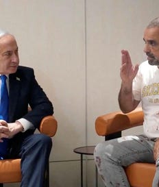 Prime Minister Benjamin Netanyahu meets Yaniv Hayun, a passenger on the flydubai flight bound for Israel from the UAE, at Ben-Gurion Airport, Wednesday.