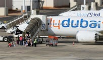 Travelers board a FlyDubai aircraft at Ben Gurion International Airport after a separate FlyDubai flight from the United Arab Emirates to Israel was diverted to Saudi Arabia following an emergency signal, in Lod, near Tel Aviv, Israel, Wednesday
