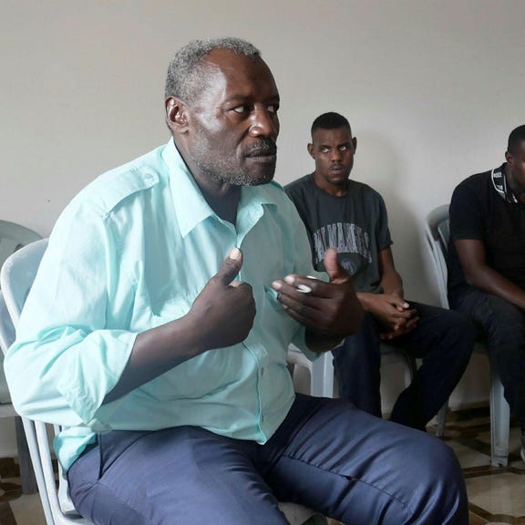 The father, Hassan, at home. He said he and his son Taha were thrown to the floor at the base for hours, their hands bound and eyes covered, shortly after his other son, Sami, was was killed.