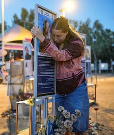 Raz Zarfati, sister of Ron Zarfati who was killed in the Oct. 7, 2023, Hamas attack on Israel, attend a memorial marking the third anniversary of the attack at the Nova music festival site near Kibbutz Reim, southern Israel, Wednesday, Oct. 7, 2026. (AP Photo/Ohad Zwigenberg)