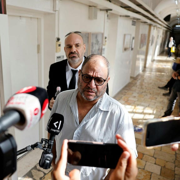 Joint List MK Ofer Cassif (right) and his lawyer, Daniel Haklai (left), at the Jerusalem Magistrate's Court, Thursday.