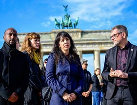 Green's Philmon Girmai (L), Die Linke's Kerstin Wolter and Elif Eralp and Werner Graf from the Greens, visit an installation to commemorate the victims of Hamas's October 7 attack, in front of Berlin's landmark the Brandenburg Gate on Wednesday