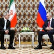 Russian President Vladimir Putin and Iranian President Masoud Pezeshkian talk during their meeting on the sidelines of an international forum in Ashgabat, Turkmenistan, 2025.