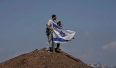 Israeli settlers on the outskirts of Beit Sahour in the West Bank on August 14. The economic repercussions of the Gaza war and surging settler violence are accelerating emigration from the West Bank.
