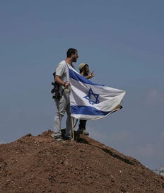 Israeli settlers on the outskirts of Beit Sahour in the West Bank on August 14. The economic repercussions of the Gaza war and surging settler violence are accelerating emigration from the West Bank.